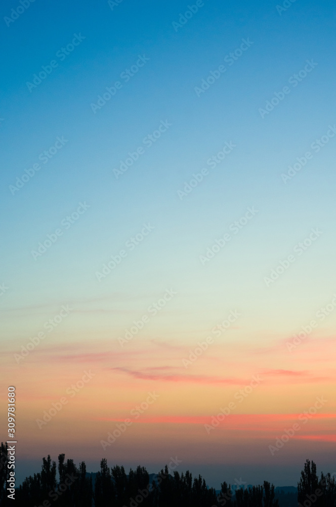 Landscape with dramatic light - beautiful golden sunset with saturated sky and clouds.