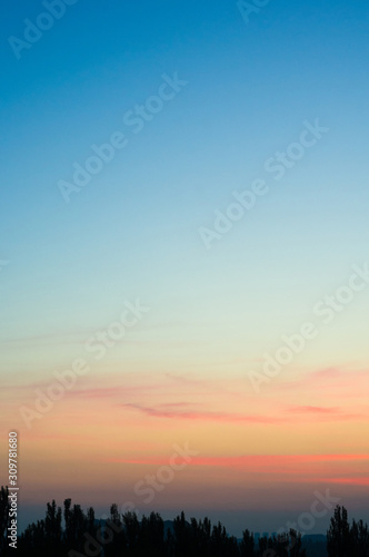 Landscape with dramatic light - beautiful golden sunset with saturated sky and clouds.