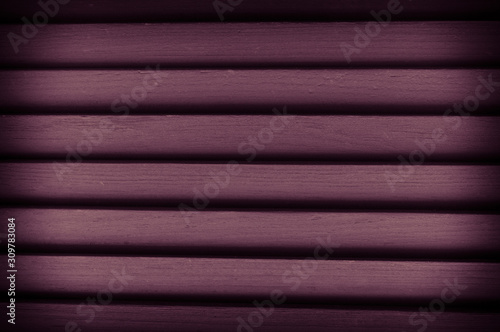 Close-up texture of wooden blinds in violet color. Natural wooden background. Photo with vignetting.