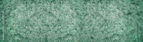 Green textured surface with dark streaks abstract widescreen background