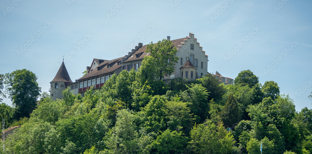 Medieval europe style castle among fresh green forest on top of hill with blue sky background , copy space, Switzerland Medieval europe style castle among fresh green forest on top of hill with blue sky background , copy space, Switzerland