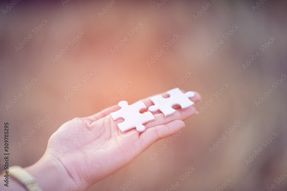 Hands and white jigsaw puzzles Close-up image and integration Business concept and unity Hands and white jigsaw puzzles Close-up image and integration Business concept and unity