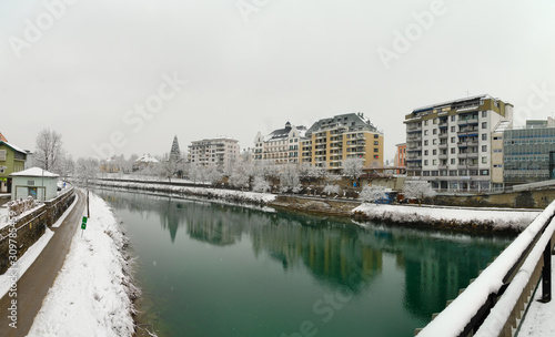Panorama of the River Drau crossing the town of Villach in Austria in a winter day during a snow storm