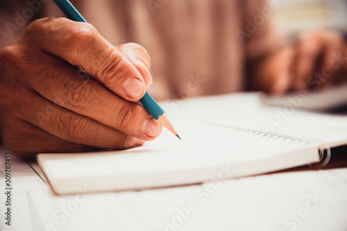 Businessman hand writing with document at work office