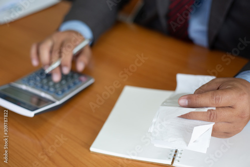 businessman hand using calculator for calculate tax in office.concept