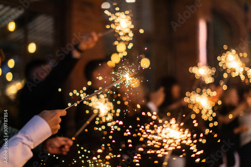 People with sparklers on outdoor party