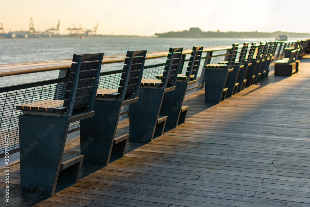 Row of Chairs along the East River in the Seaport area of New York City during Sunset