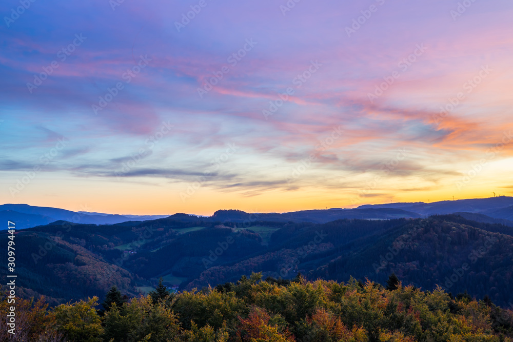Obraz premium Germany, Impressive aerial view above endless beautiful black forest holiday nature landscape above tree tops at sunset in autumn season