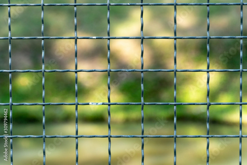 Steel grating for wall fencing With green nature as the background.