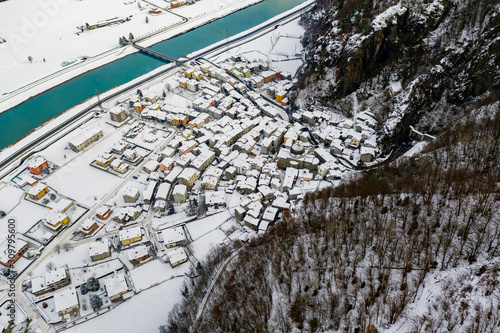 Valtellina (IT) - Panoramic aerial view of the Adda river and the Sirta village in winter