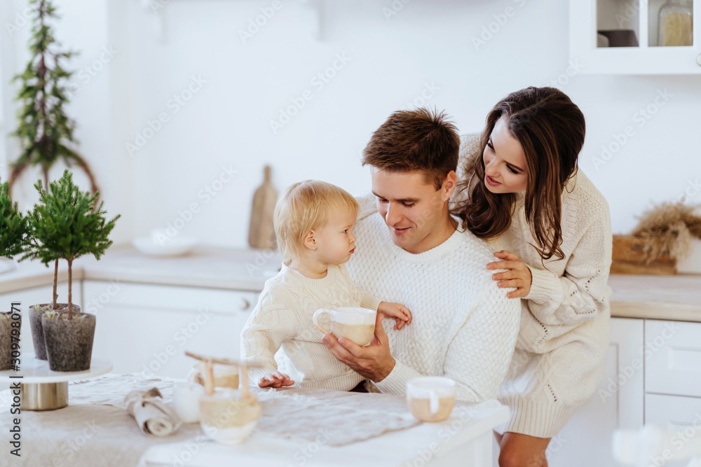 Happy family with children rolling dough in Christmas kitchen.