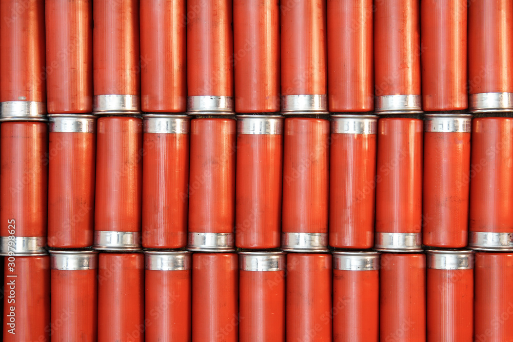 Red 20 gauge shotgun shells in a pattern laying flat. Red 20 gauge shotgun shells in a pattern laying flat.
