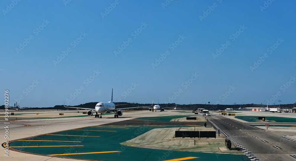 Planes Taxxing on Runway in a Commercial Airport Planes Taxxing on Runway in a Commercial Airport