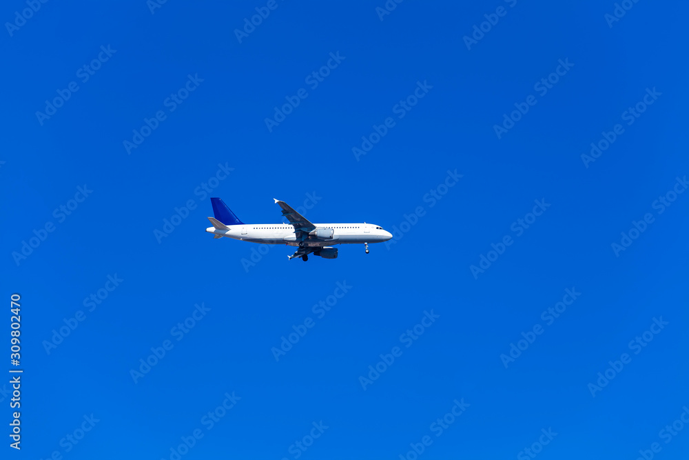 Comercial airplane flying in a beautiful blue sky day Comercial airplane flying in a beautiful blue sky day