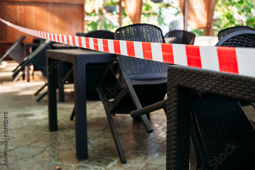 stretched security tape at tables in a street cafe