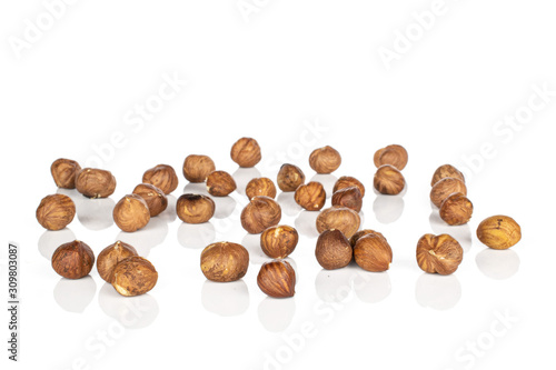 Lot of whole disordered tasty brown hazelnut isolated on white background