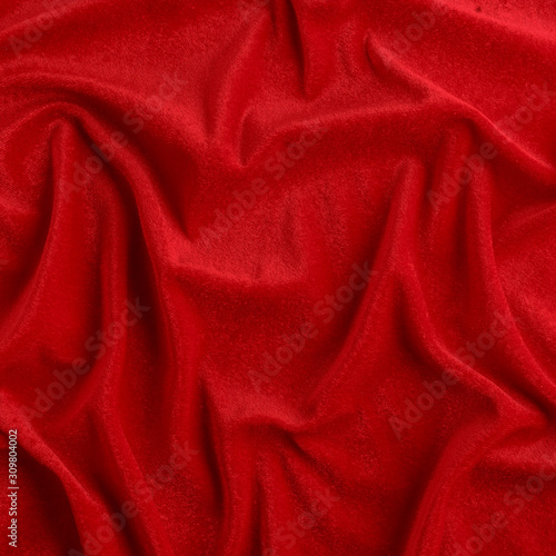 Wavy red silk, atlas or veil fabric, crumpled with creases, bended in spiral wrinkle