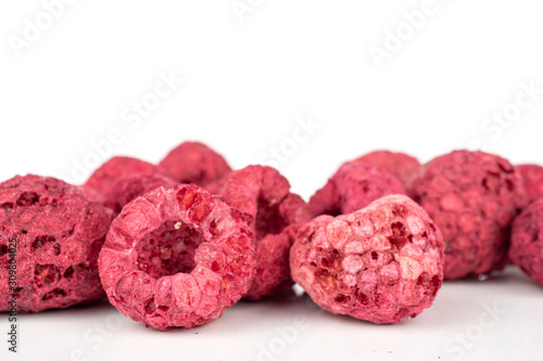 Lot of whole bright dried raspberry closeup isolated on white background