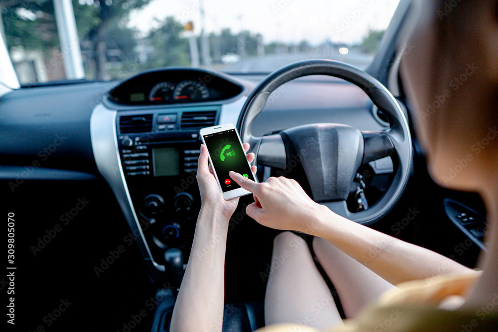 Close-up of woman talking on mobile phone while driving a car. Close-up of woman talking on mobile phone while driving a car.