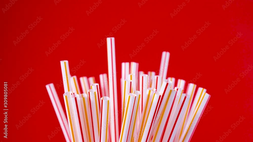 Cocktail tubes on a red background. Festive mood. Cocktail tubes on a red background. Festive mood.
