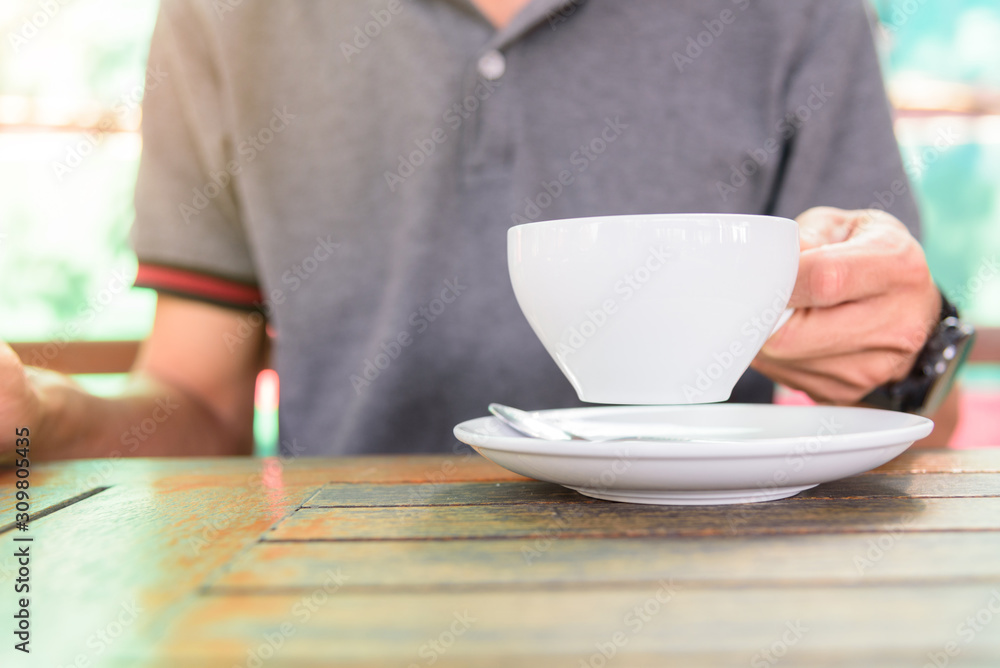 The man take the hot coffee to drink The man take the hot coffee to drink