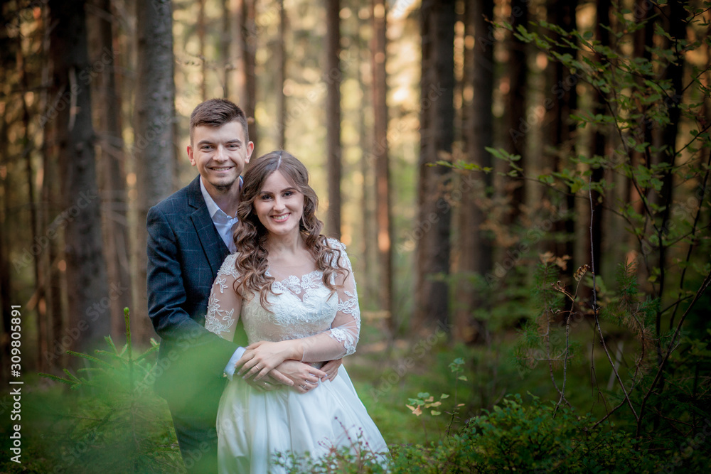 Bride and groom in forest on their wedding, photo session.