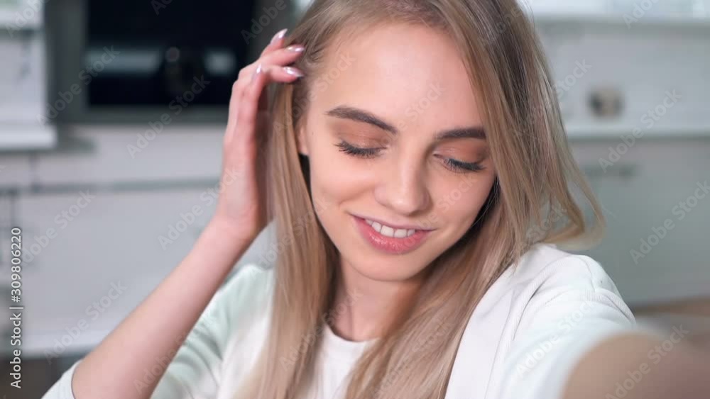 Portrait of beautiful, cheerful woman taking selfies indoors. Slowmotion. Handheld shot. Portrait of beautiful, cheerful woman taking selfies indoors. Slowmotion. Handheld shot.