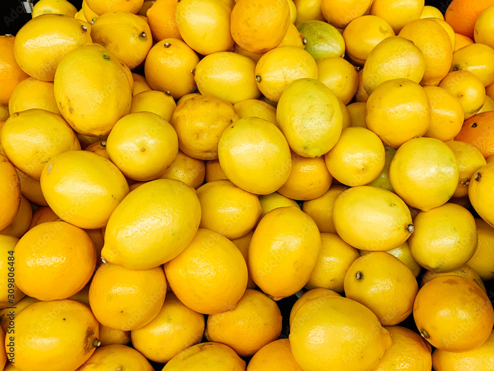 lots of yellow sour lemons to eat as a background