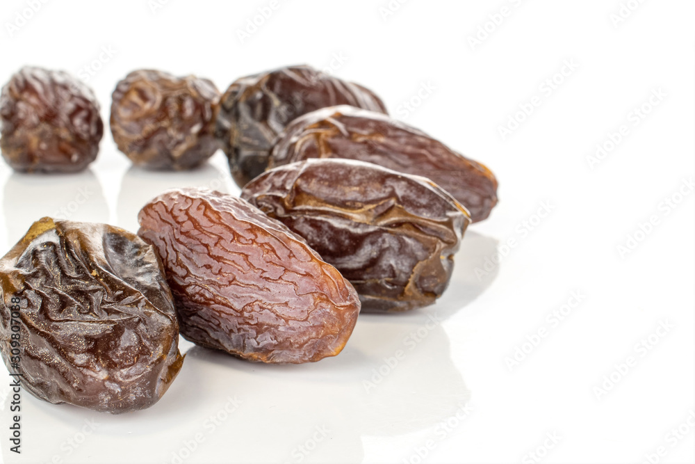 Group of seven whole dried brown date fruit half circle isolated on white background Group of seven whole dried brown date fruit half circle isolated on white background