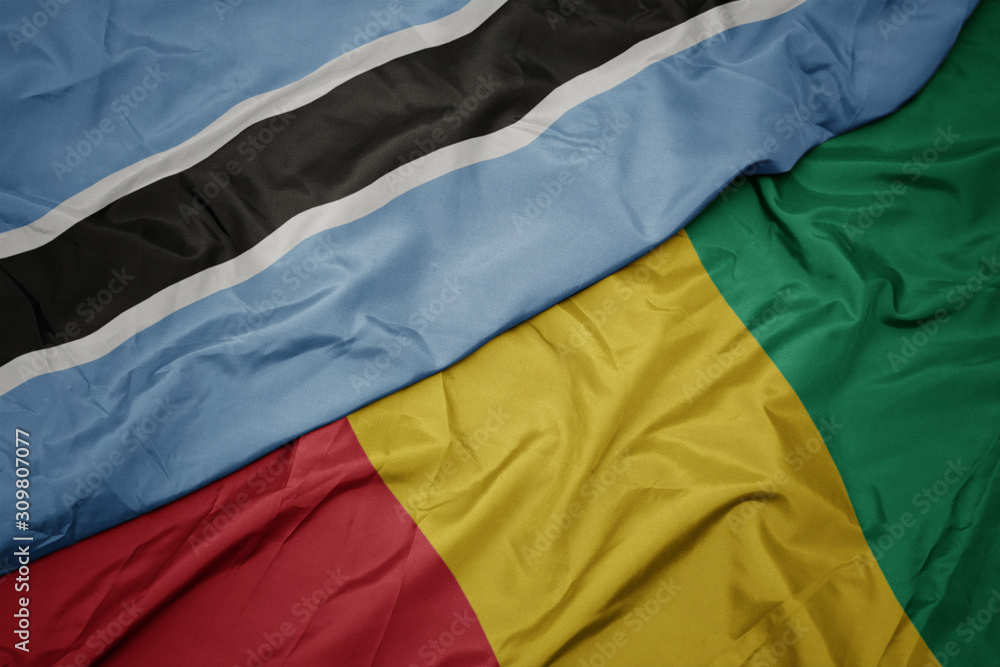 waving colorful flag of guinea and national flag of botswana.