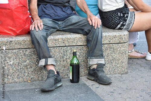 Drunk man on the street. Alcoholism treatment. photo