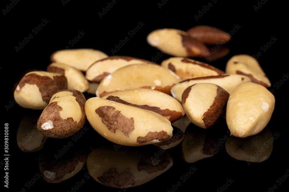 Lot of whole brazil brown nut isolated on black glass Lot of whole brazil brown nut isolated on black glass