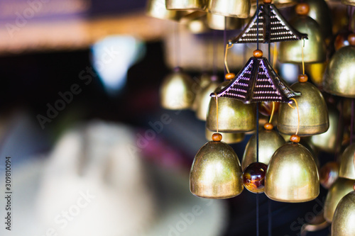 Small ring bells hanging. Many of tiny golden bell hanging in tempel.