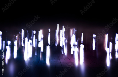 Empty dark background scene of the show. Neon ultraviolet blurry lights. Blurry lights of the night city in reflection on the surface. Smoke, fog