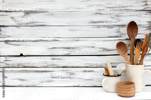 Vintage old baking utensils on a white wooden background.