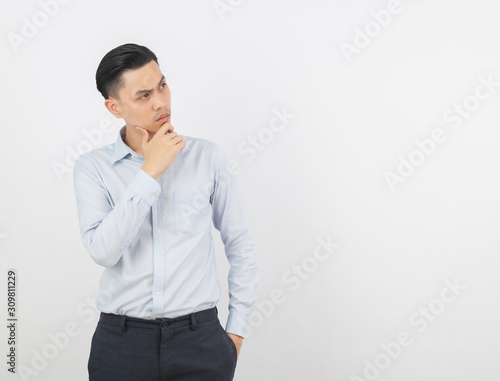 Young handsome asian business man thinking an idea while looking up isolated on white background.