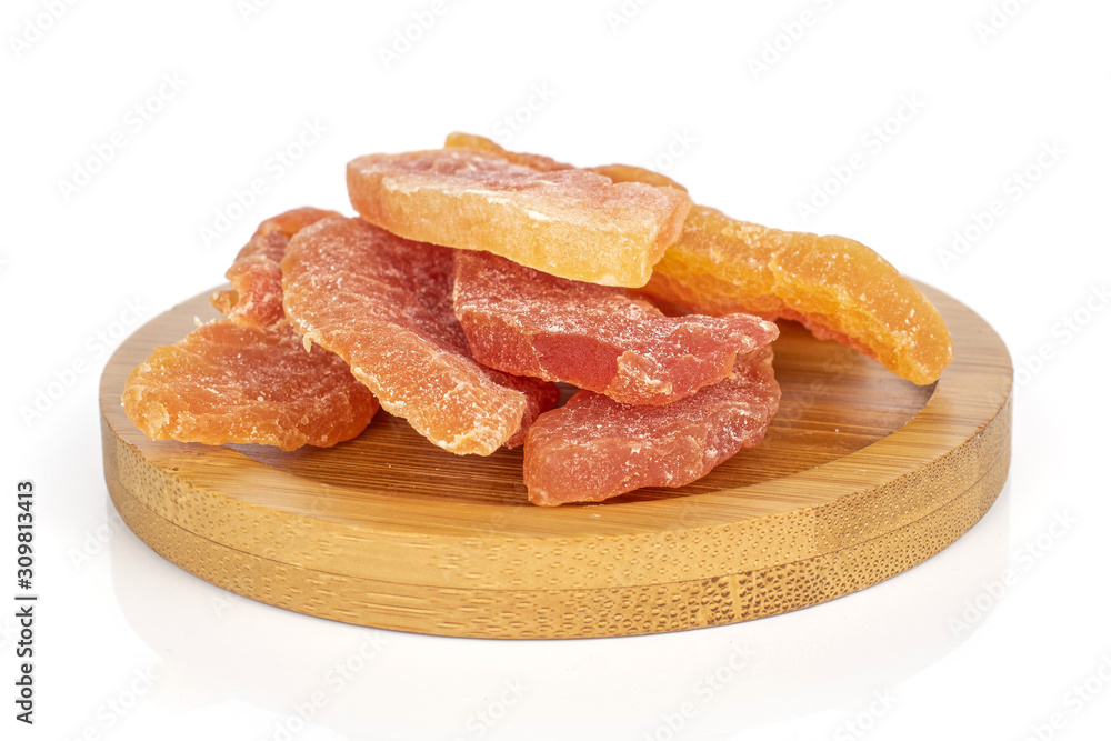 Group of six whole dried orange papaya piece on round bamboo coaster isolated on white background Group of six whole dried orange papaya piece on round bamboo coaster isolated on white background