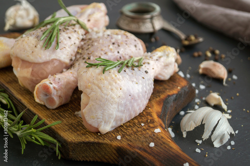 raw chicken legs with spices. ingredients for cooking.
