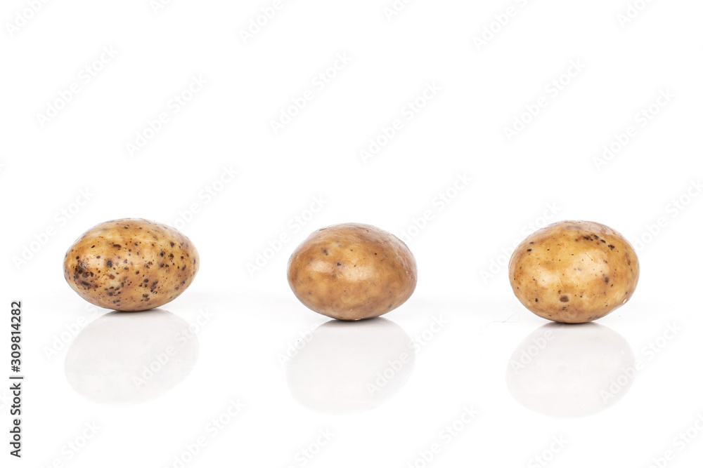 Group of three whole tiramisu brown almond nut isolated on white background