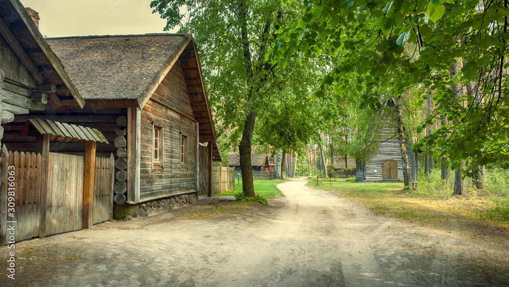 Riga,  Latvia, panorama old wooden village with residential buildings, a chapel in the forest of the Ethnographic Museum in the open air 