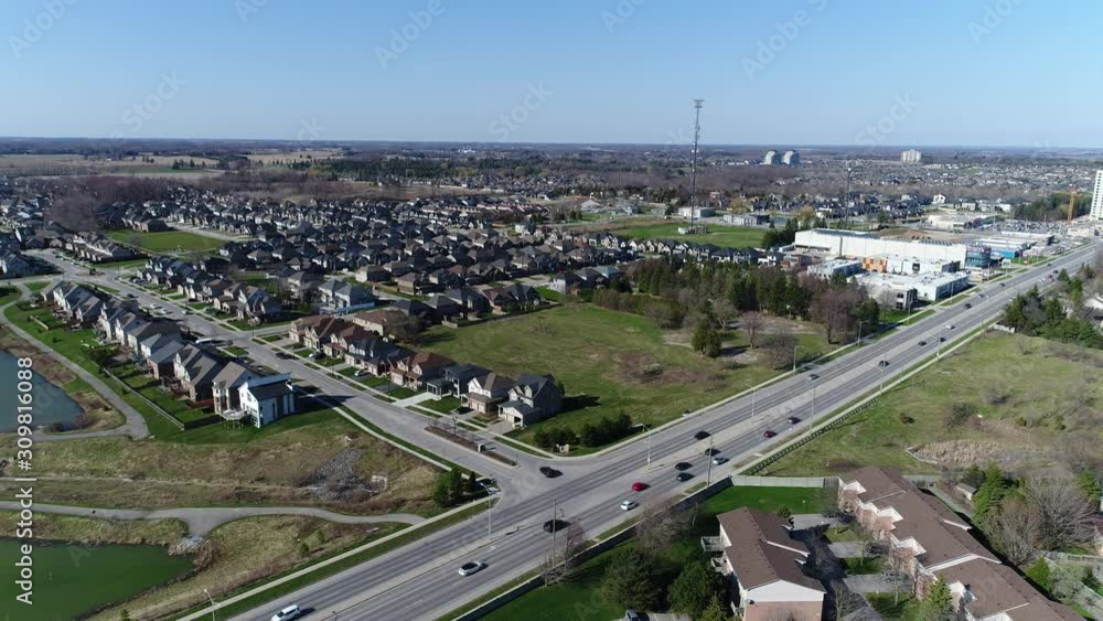 Two Lanes Of Car Traffic Aerial Towards City Center With Radio Tower From Suburban Neighborhoods Two Lanes Of Car Traffic Aerial Towards City Center With Radio Tower From Suburban Neighborhoods