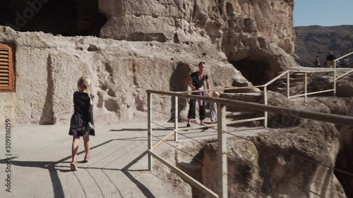 female child running in cave city to mother