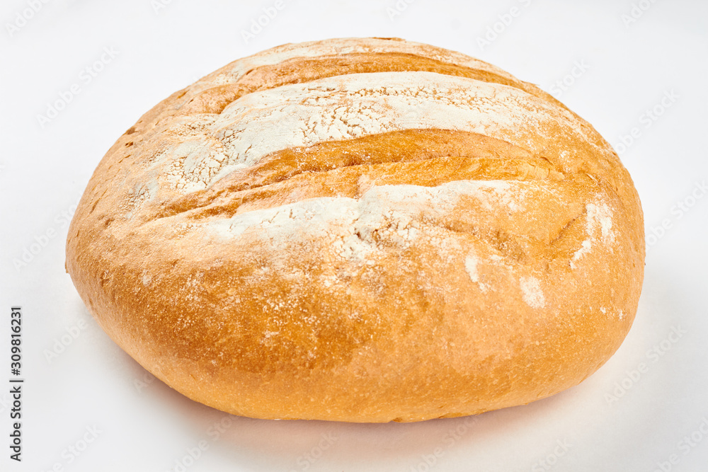 Loaf of fresh bread on white background. Delicious wheat bread. Easy artisan bread recipe.