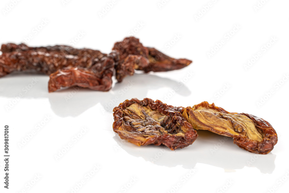 Lot of whole dried red tomato piece two in focus isolated on white background
