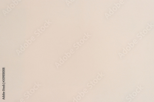 Simple beige stucco background. The texture of the light wall.