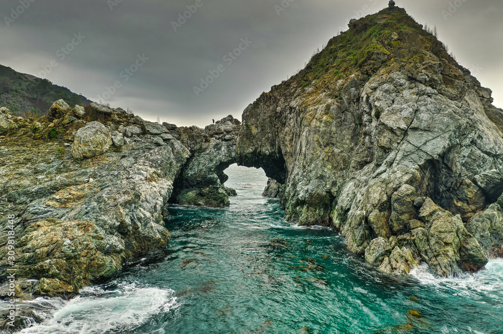A natural arched rock in the ocean