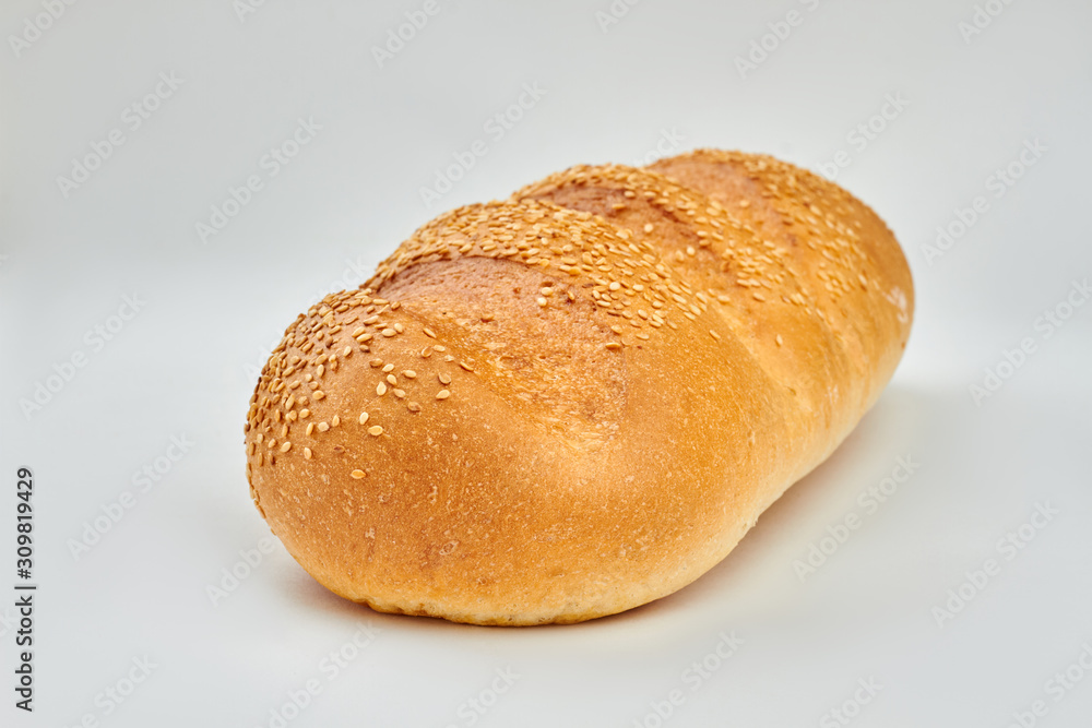 French bread with sesame seeds. Loaf of fresh bread isolated on white background. French bread with sesame seeds. Loaf of fresh bread isolated on white background.