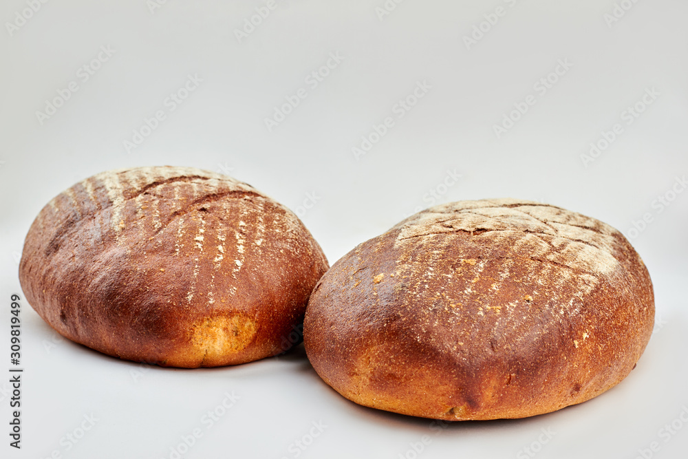 Two loaves of freshly baked bread. Artisan bread isolated on white background. How to bake healthy bread. Two loaves of freshly baked bread. Artisan bread isolated on white background. How to bake healthy bread.