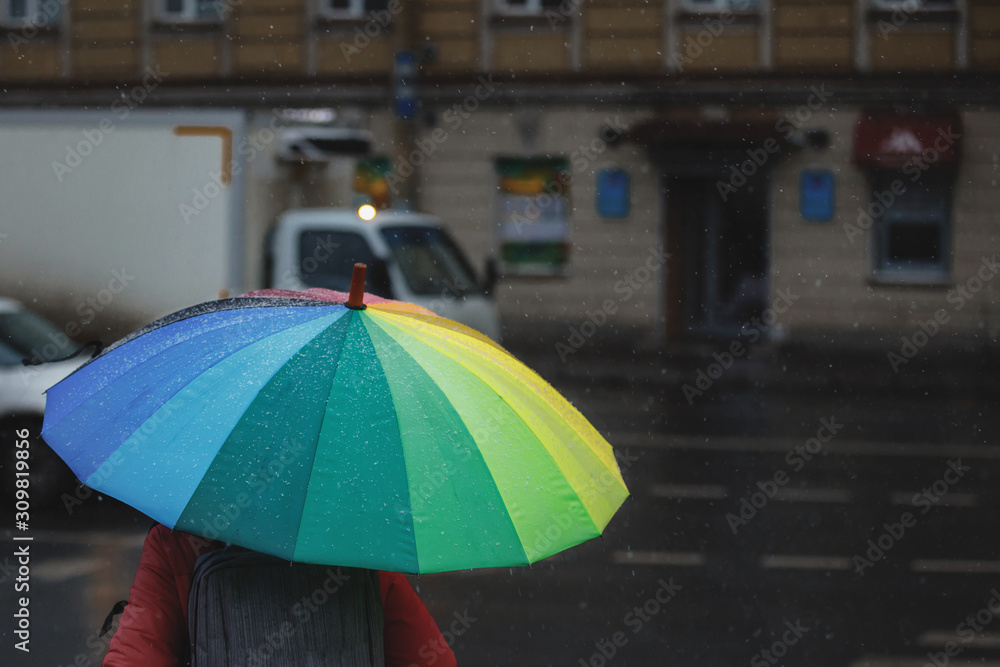 bright multi-coloured umbrella in rainy weather