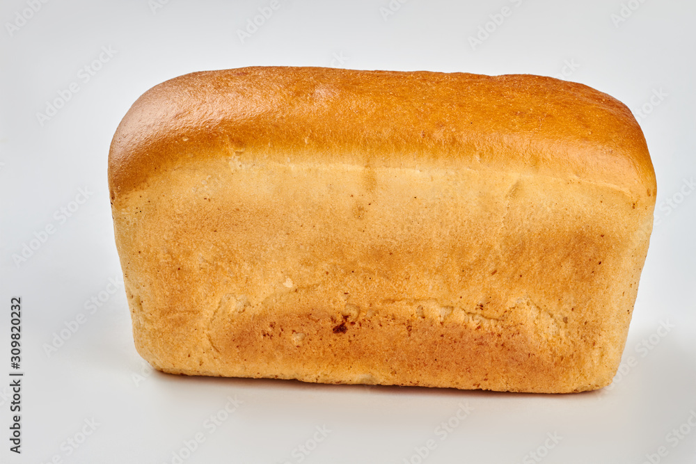 Traditional square loaf of bread. Bread on white background, side view. Traditional square loaf of bread. Bread on white background, side view.